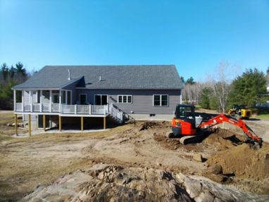 Reliable landscaper near Fremont NH for residential retaining wall and patio installation with mini excavator.