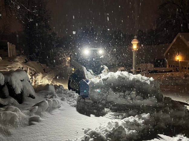 Reliable landscaper near Manchester NH for commercial snow removal with a skidsteer