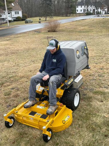 Reliable landscaper for residential lawn care with Walker mower.