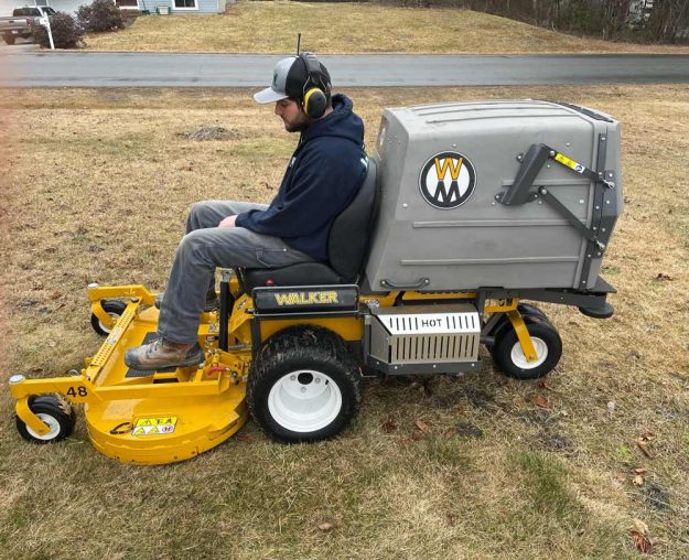 Reliable landscaper for residential lawn care with Walker mower.